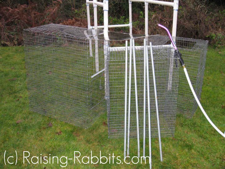 Cages and PVC rabbit hutch frame pulled outside and dismantled for cleaning. Cages and PVC rabbit hutch frame pulled outside and dismantled for cleaning.